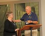 Post 370 Legionnaire Bill Edwards presents Janet McCloskey a gift card to Wolfgang's Restaurant and Wine Bistro.